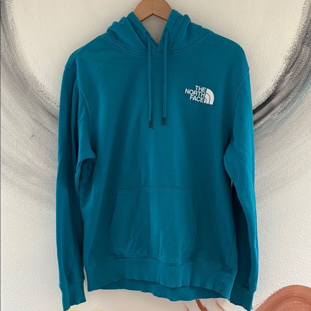 The North Face Men's Blue Hoodie. Size Medium. Drawstring hood.